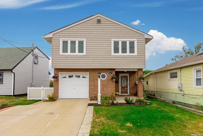 Welcome Home to this immaculate Custom Colonial High Ranch located in Lighthouse Point Lindenhurst. This home has ample space for a large family or entertaining. Eat in Kitchen has oak cabinets and newer stainless appliances , gas cooking as well as cathedral ceilings . The large living space completes the opened concept . Primary bedroom , updated bathroom as well as two generous bedrooms complete the first floor. Downstairs boasts a large entry hallway, laundry room , garage , fourth bedroom or office space, bathroom and large living space with outside entrance to beautiful updated deck. New Windows and owned Solar Panels with electric bills ranging from $15-$18 dollars a month is a wonderful extra . Transferable flood insurance policy. 12 Month Home Warranty available for purchase.