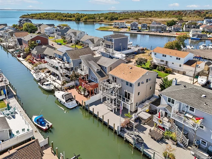 Waterfront Dream Home with Spectacular Sunsets Experience the ultimate coastal lifestyle with a short boat ride to Fire Island or Jones Beach. The multi-level composite decks provide ample space for relaxation and entertaining while offering breathtaking views of the water.