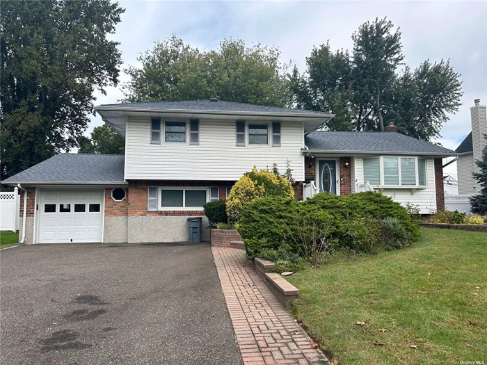 Lovely updated Split with Updated Kitchen and Baths, Large Den Fireplace, Wood Floors, Gas Heat, Beautiful Yard with Gunite Pool, 1 car Garage with extra wide driveway...