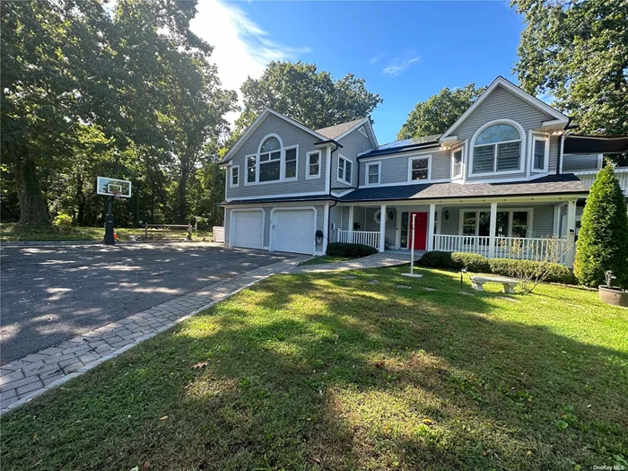 Elegant Colonial Home with 4 Bedrooms and 3.5 Bathrooms Discover this beautifully designed colonial home featuring 4 bedrooms and 3.5 bathrooms, perfectly situated on a generous 78 x 135 lot in the desirable beach community of Bayville. This eco-friendly residence features owned solar panels and an electric car charger, providing excellent energy efficiency and significant savings on utility bills. As you enter through the welcoming front porch, you&rsquo;re greeted by a grand double-height foyer complete with a powder room and an interior elevator for easy access. The elegant living room and dining room provide an ideal setting for formal gatherings, both adorned with panoramic windows that frame stunning views of the landscaped backyard. The heart of the home lies in the open-concept family room and kitchen, where sliding glass doors lead to an expansive deck and steps to the backyard-perfect for outdoor dining and entertaining. The eat-in kitchen boasts a spacious island, custom cabinetry, luxurious marble countertops, and a pantry, catering to culinary enthusiasts. Cozy up in the family room, highlighted by a sophisticated black marble fireplace. The attached two-car garage is equipped with an electric car charger for added convenience. Accessed via interior stairs or a separate outdoor entrance, the second floor features a luxurious master bedroom with a cathedral ceiling, private balcony, walk-in closet, and a spa-like master bathroom with a jacuzzi. Two additional bedrooms offer spacious closets and comfort, while a stunning double-height sunroom/family room features cathedral ceilings and opens to a balcony connected to the deck by a spiral staircase, creating the perfect space for relaxation and casual gatherings. An office and full bath round out this level, adding versatility for work or guests. The finished basement includes an expansive entertaining room that opens to the backyard, perfect for gatherings and fun. Enjoy additional features such as a wine cellar, gym, laundry room, and another full bath. Turn this exceptional property into your dream home, located in the Locust Valley School District and close to beaches, restaurants, churches, and shopping.