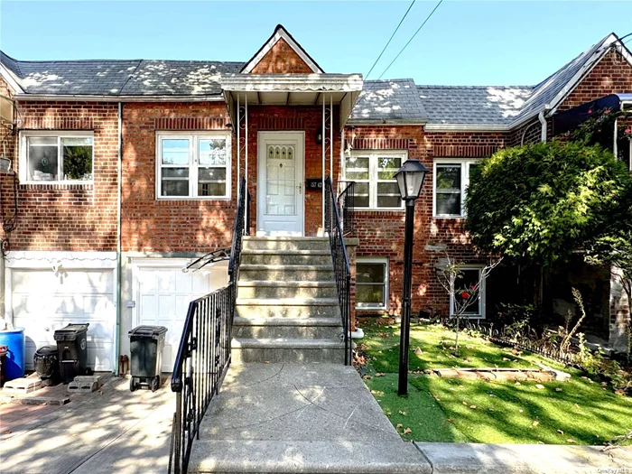 Welcome to this charming brick single-family home nestled in the heart of Queens, offering south-facing sunlight. With 2, 050 square feet lot, the first level features a spacious living room, dining room, kitchen, two large bedrooms, and a full bathroom. Gorgeous hardwood floors. The walk-in level basement includes a family room, a newly renovated full bathroom, washer and dryer, and separate entrance to both the backyard and the street. The backyard is beautifully paved. Additional highlights include an attached 1-car garage, private driveway, and central air conditioning. Conveniently located near several bus stops, the LIRR, major highways, schools, Bowne Park, shops, and restaurants, this home offers the ideal combination of comfort and convenience. Don&rsquo;t miss your chance to make it yours!