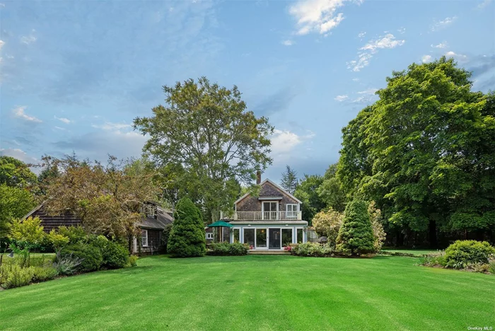 On Golden Pond. Discover an extraordinary and secluded lot for sale in the prestigious Water Mill area, boasting an impressive 8.8+/- acres of pristine land on the stunning Golden Pond. Located at 61 Lower Seven Ponds Road, this property offers numerous possibilities, whether you envision constructing a new masterpiece or enhancing and expanding the existing structures. With the right vision, this expansive 8+ acre site can be transformed into a breathtaking waterfront compound. The property is set in a spectacular, park-like environment, featuring open lawns framed by mature landscaping, privacy and luxury. The western views over the pond provide some of the most romantic sunsets in the Hamptons, making it an idyllic retreat. Currently, the property includes a spacious 4, 000+ sq/ft main residence, a separate charming cottage, a barn, a garage, and a heated gunite pool. Additionally, there is ample space on the site for a tennis court and other recreational amenities. It also features a long driveway that could be gated, a beautiful approach to your compound. This is a rare opportunity in the Hamptons to create your custom dreamscape on the pond in Water Mill, where the possibilities are as vast as the views.