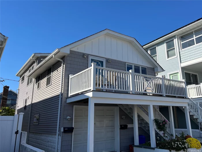 Legal Two-Family on West End Wide Block. Garage & Storage room w/wall-hung boiler on ground level. 14 steps up to Front Deck & entrance to Livingroom & Dining Area w/Vaulted Ceiling & Coat Closet. Kitchen has breakfast bar open to the living area. Half-Bath has marble vessel sink & pocket door. Six steps up to 2 bedrooms & full bath & stack washer/dryer. Upper deck off the primary bedroom. The rental apartment is in the back of the house--6 steps up to a deck & entrance to the livingroom, kitchen, bedroom & full bath. Apartment has 3 closets & door to basement with its own washer/dryer. House was completely renovated in 2011. Central air in the main apartment. Separate electric meters.