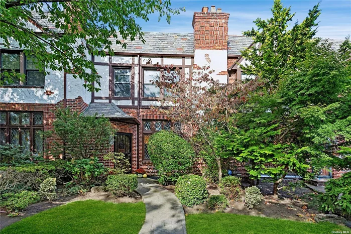 Welcome to 90-07 68th Avenue, a stunning Tudor-style residence crafted by the renowned Wolosoff Brothers. Upon entering, you&rsquo;re immediately captivated by the sunken living room, featuring a charming wood-burning corner fireplace, leaded glass windows and a dramatic high ceiling with hand-hewn exposed beams. The elevated formal dining room offers ample space for hosting gatherings, while elegant French doors provide a seamless connection to the inviting back patio-ideal for indoor-outdoor entertaining. The spacious kitchen, featuring white cabinetry, offers an eat-in area for casual dining. A lovely window above the sink frames serene views of the backyard. A conveniently located half-bath completes the main level. Upstairs, the home boasts three generously sized bedrooms and an oversized bathroom with dual access-one from the primary bedroom and one from the hallway. This expansive bathroom features a stall shower, a mirrored vanity area, and a separate soaking tub with shower. With its generous layout, the bathroom could easily be reimagined as two separate spaces, offering additional comfort and convenience for family or guests. The finished basement adds even more versatility, with a large recreation room anchored by a corner fireplace, a dedicated office, a full bath, and a laundry area with direct access to the backyard. Outside, a large private back patio and beautifully landscaped front gardens enhance the home&rsquo;s curb appeal. A detached standalone garage completes this exceptional property. Don&rsquo;t miss the opportunity to own this remarkable Tudor in the heart of Forest Hills-a true blend of historic charm and modern convenience!