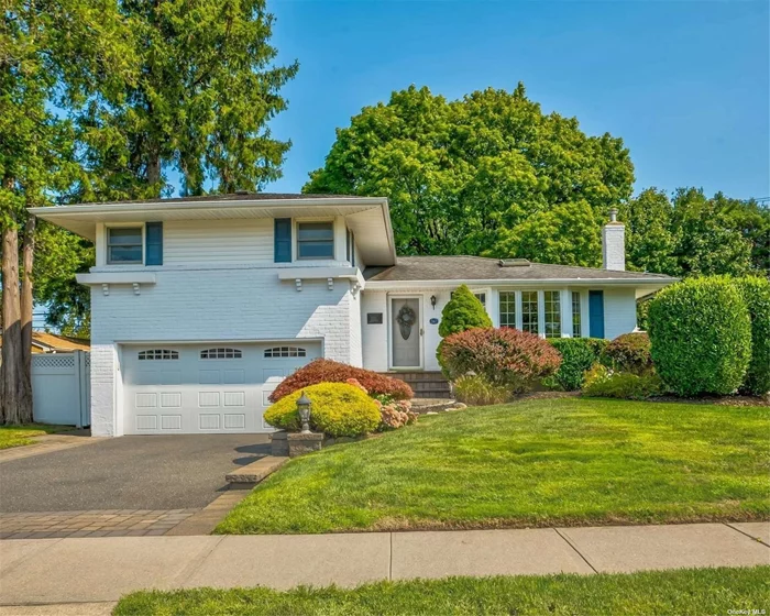 Welcome to this Gorgeous Split in Syosset. Enter the Formal Living room and marvel at the natural light, hardwood floors and beautiful moldings. The formal dining area is spacious and inviting, which opens into the updated kitchen. Stainless Steel, Granite and Eat In makes it a perfect home to host many gatherings. Upstairs includes the Primary Suite, with a beautiful updated bathroom. Two additional bedroom and a Full Bathroom with tub finishes the upper floor. The lower level opens to a huge family room, with sliders to the private yard along with access to the 2 car garage. The basement includes a finished den with plenty of light, a true 2nd Family Room perfect for extra entertaining. Utilities and Laundry along with a bonus bathroom finish out the basement. Nestled in Syosset on a perfect tree lined block, this home will meet all your need. Unpack and Live......