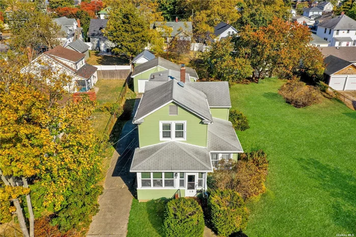 Welcome to 19 West Drive, a charming colonial home in the heart of Bay Shore, offering the perfect blend of location, lifestyle, and historical charm. Built in 1922, this classic residence boasts timeless artisan craftsmanship of a bygone era including hardwood floors, moldings and staircase banister artfully constructed by a master-craftsman. The inviting front porch is perfect for morning coffee or evening relaxation. Step inside to an enduring and seamless designed floorplan with a well-appointed formal living with adjoining den/sunroom.  The eat in kitchen and adjoining formal dining room offers the perfect place for gatherings, and as a bonus you will find a mudroom/laundry room off the kitchen with door to the backyard as well as a half bath. The second floor is highlighted by a large primary bedroom suite, complete with an adjoining versatile sitting room that can easily serve as a third bedroom, or home office. Another full bedroom and a full bath complete this level. The unfinished basement with Bilco doors provides additional storage or potential for future finishing. The property includes a large detached two-car garage with an attached workshop, ideal for car enthusiasts or hobbyists. The expansive side yard is a gardener&rsquo;s dream or a fantastic space for outdoor entertaining. Enjoy the convenience of being just minutes from the vibrant downtown Bay Shore, where award-winning restaurants, boutique shopping, and entertainment options await on Main Street. For those commuting to the city, the nearby Bay Shore train station provides easy access to NYC, making this home an ideal choice for professionals seeking suburban tranquility with urban convenience. Nature enthusiasts will appreciate the quick access to Robert Moses Beach and the Fire Island Ferries, perfect for weekend getaways or a relaxing day by the ocean. This prime location truly offers it all-an unparalleled lifestyle close to everything you love.  Don&rsquo;t miss the opportunity to own this beautiful home in a sought-after location, offering a lifestyle that truly has it all!