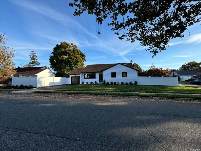 Nestled in the serene community of East Meadow, NY, within the highly sought-after Barnum Woods school district, this expansive, newly renovated Del Rio Ranch home is situated on a desirable corner lot. The exterior, thoughtfully updated with a timeless charm, opens to reveal a beautifully spacious and fully modernized interior designed to impress with its perfect blend of style, comfort, and functionality. The home features four generously sized bedrooms, including a private en-suite in the primary bedroom, providing comfort and convenience. Additionally, there are two beautifully designed full bathrooms, complete with tiled showers, ceramic floors, and dual sinks, all crafted with high-quality finishes. The sunken living room is bathed in natural light, creating a warm and welcoming atmosphere that invites relaxation or the opportunity to entertain guests. Adjacent to the living space, the dining room includes a thoughtfully designed buffet station with custom cabinets, quartz countertops, glass doors, and a 48-bottle wine cooler, providing an elegant space for hosting dinners or holiday gatherings. At the heart of the home is a large custom kitchen that will delight any cook. It boasts new quartz countertops, custom cabinets, and top-of-the-line GE stainless steel appliances, including a stove, refrigerator, dishwasher, microwave. The kitchen is further enhanced by an L shaped nook, offering a cozy space for casual dining. Downstairs, the fully finished basement provides ample room for recreation, hobbies, or a home office. With 6 wide waterproof laminate flooring, mini LED high-hat lighting, a cedar closet, and a high-efficiency washer/dryer combo, this space is as functional as it is comfortable. The exterior of the home has also seen significant upgrades, including new 8 clapboard siding, new gutters, leaders, and a newer roof, all contributing to the home&rsquo;s long-lasting durability and charm. The windows and doors, including a sliding door, front door, and screen door, have been replaced to improve both energy efficiency and aesthetic appeal. Outside, the spacious, dual-fenced yard is perfect for outdoor enthusiasts. Whether hosting barbecues, parties, or simply enjoying a peaceful evening under the stars, this outdoor space provides endless possibilities. The yard features new sod and plantings, enclosed by a six-foot PVC fence for added privacy, and is kept lush and green with the new in-ground sprinkler system. The home is equipped with updated systems for optimal comfort and efficiency, including a five-year-old boiler, a new three-zone heating system with programmable thermostats, and a new central air conditioning system with updated ductwork. A new hot water heater, as well as a complete overhaul of the electrical (200 amp service) and plumbing systems, ensure that this home is as efficient as it is stylish. Additional features include new hardwood floors and kick moldings throughout, new LED mini high-hat lighting, a new driveway and walkway bordered by Belgium blocks, and newly installed front steps. The one-car garage provides ample storage and has been updated with new attic access stairs. Inside, the home provides an abundance of closets, ensuring plenty of space for storage and organization. This East Meadow gem provides the perfect blend of modern convenience and suburban tranquility. With its extensive renovations and ideal location near schools, parks, and shopping, this home is truly move-in ready. Discover the charm and potential of 1486 Cleveland Avenue and embrace the suburban lifestyle you&rsquo;ve been looking for.