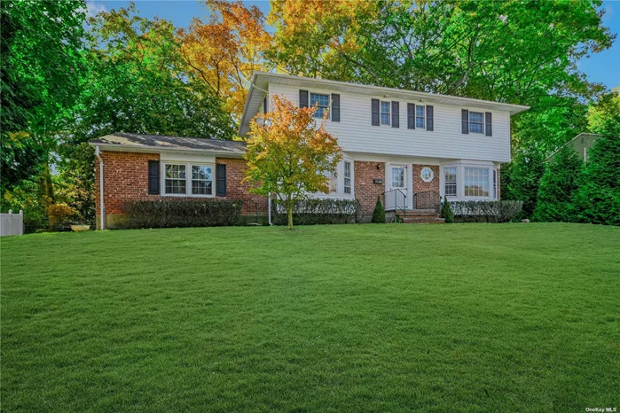 Welcome To 18 Kingfisher Drive. This Wonderful Forestwood Section Center Entrance 4 Bedroom 2.5 Bath Colonial Features Oak Hardwood Floors, Fresh Modern Paint, Quality Andersen Replacement Wood Windows, Updated Tiled Baths W/ Kohler Fixtures/Pedestal Sinks And Solid Surface Countertops, Updated Light Fixtures, Lovely Brick Wood-Burning Fireplace, Exposed Wood Beams, Huge Rear Flexible Addition With Walls Of Windows, Good Sized Bedrooms Including Front-To-Back En-Suite Primary With Walk-In Closet, Front-Load LG Washer And Dryer, Central Air Conditioning, Updated Electrical Service/Panel, Bonus Semi-Finished Basement With Multiple Rooms & Storage, Newly Painted Exterior, Architectural Shingle Roof W/ Newer Gutters, Huge 2 Car Garage W/ Storage, Professionally Landscaped Lawn/Grounds With Sprinkler System, Young Septic/Cesspool, All Situated On A Fenced Flat 1/2 Acre Lot In Walking Distance To Blydenburgh Park And Short Drive To LIRR And Bustling Smithtown Village Shops, Restaurants, Performing Arts Center, And Much Much More. Live The Idyllic Life!