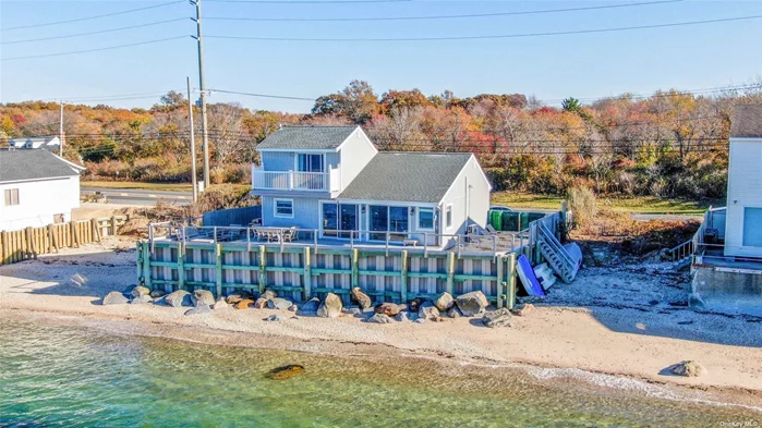 Views that never end! Welcome to your picturesque beachfront retreat along the Long Island Sound, where breathtaking water views and private beach access create a serene escape. Enjoy year-round sunsets that will take your breath away. This charming home features a fantastic layout with sun-soaked, high ceilings in the great room, seamlessly connecting the eat-in kitchen, living room, and dining area. The large elevated waterside deck offers easy access, perfect for entertaining or simply soaking in the beauty of your surroundings. The main level accommodates two spacious bedrooms and a full bathroom, while the second level is dedicated entirely to a luxurious primary bedroom complete with an ensuite bathroom and a private waterside balcony-ideal for enjoying quiet moments overlooking the water. Don&rsquo;t miss this incredible opportunity to own your slice of heaven on the North Fork!