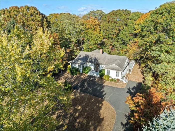 Laurel beautiful mid-century modern ranch style home on shy acre property just before Mattituck! This home has double entry doors to a spacious entry foyer to welcome your friends and family! Living room and dining room with cathedral ceiling and skylights. Hardwood floors, eat in kitchen, 3 bedrooms and 2 full baths. Main bedroom with en suite bathroom and walk in closet. This bedroom has sliders to large deck facing private backyard that borders open space. Two car garage under with full storage basement, utility and laundry room. This is the place centrally located on the beautiful North Fork. Minutes to Greenport, and a short hop to the Hamptons! This wine country escape is welcoming and ready for you to make yourself at home!