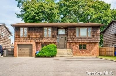 Welcome home to this charming hi-ranch in East Northport. Conveniently located close to all transportation, shops, parks, schools, and highways. This home boasts plenty of natural light, with 4 bedrooms and 3 full baths. Central Air upstairs is only 3 years old. Sliding glass doors lead out to a spacious, fenced backyard with brick walkways and a slate bbq area. The upstairs living area is open concept, with cathedral ceilings in the living and dining rooms. Hardwood floors under wall to wall carpet. Potential for an accessory apartment if owner occupied. A must see!