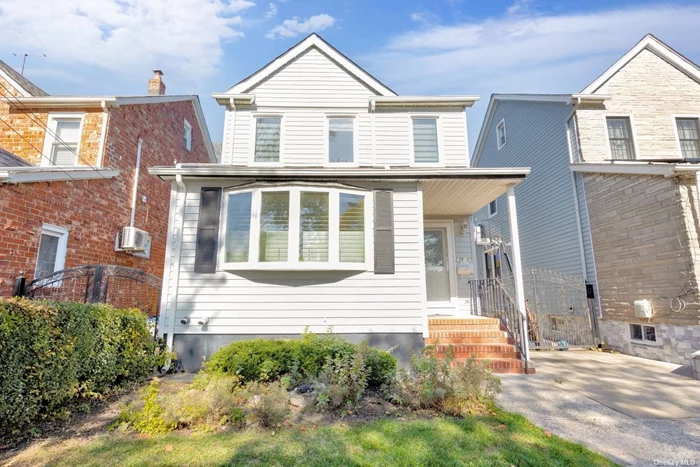 Welcome home to this triple mint Bellerose beauty on a rare 166ft deep lot! TONS of upgrades in this home. First floor features open concept with living room, dining room, and custom kitchen featuring stone countertops, modern appliances, stove hood that vents out and radiant heat. Super convenient half bath on 1st floor. LED lights and split system AC throughout. The 2nd floor features a modern bathroom with double sinks and LED lights along with 3 bedrooms. The highly insulated walk up attic provides a nice bonus space. Full finished basement with separate entrance. Sliding doors from the first floor lead to your giant backyard oasis! The 166 feet deep yard features a storage shed (in addition to the one car garage), an enclosed solarium, brand new PVC fencing, outdoor fire pit seating area, PIZZA OVEN!, and pergola! THIS IS A TRUE MUST SEE.  Upgrades include all new windows, updated electrical, tankless hot water heater. Too many upgrades to list! Please call today.