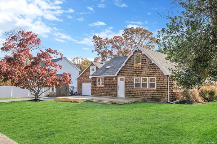 Located in the desirable community of Patchogue Shores, this renovated Cape-style home is an Everything Property. Featuring ageless hand-split cedar shingles, numerous gables, and several skylights. There is a detached two-car garage with a full-size office/studio above for convenience. The open-layout kitchen has shaker-style cabinets, quartz countertops, and stainless appliances. This is an open-concept layout that includes a very well-designed dining area. Hardwood floor throughout and a living room with a beautiful fireplace. There are 2 bedrooms on the first floor and 2 bedrooms and a studio on the second floor. The mechanical system includes cast iron baseboards and central air conditioning, which is propane-fueled. There is also a full laundry room, a large wood deck, and an inground sprinkler system. This is an awesome home for anyone working from home or who is an Artist and needs Studio Paradise.