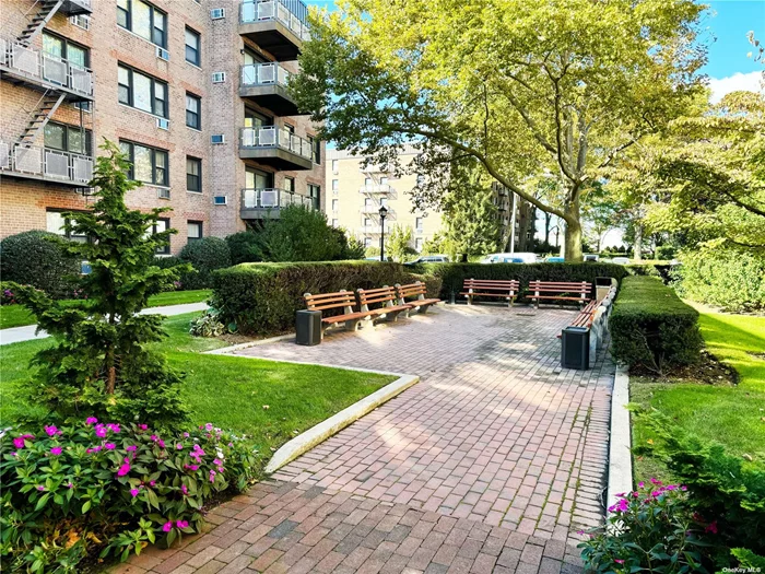 Step into this expansive, move-in ready 2-bedroom, 2-bathroom corner unit, thoughtfully refreshed with modern touches. The apartment boasts an open-concept layout, with a stylish kitchen featuring updated cabinetry, stainless steel appliances, and polished granite countertops. There&rsquo;s a convenient office nook, ideal for working from home. Enjoy two serene, earthy bathrooms, and hard wood flooring that adds a sophisticated touch throughout. The space is bathed in natural light and offers ample closet storage. Set in a peaceful area of the complex, this home is part of a secure 24-hour gated community. It&rsquo;s located close to the LIRR, NYU Langone Winthrop Hospital, Roosevelt Field Mall, and various shopping and dining options. A transferable parking spot near the unit is also included. This one is not to be missed!