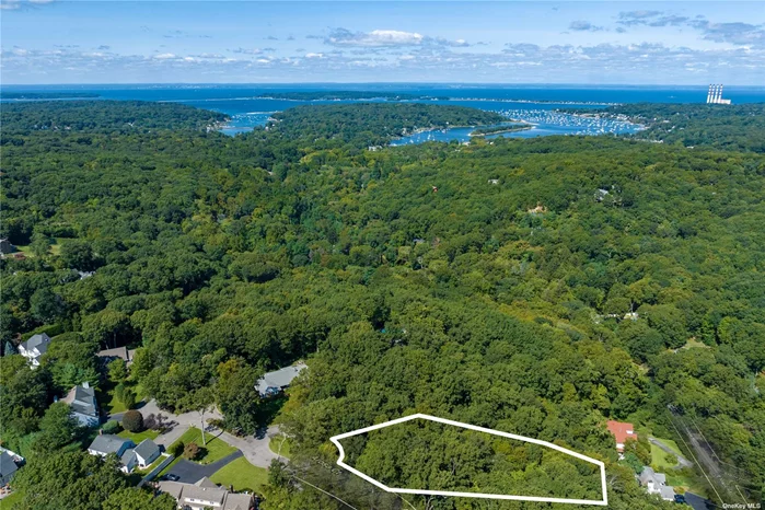 Rare opportunity to purchase scenic, vacant land at the end of a cul-de-sac on quiet and quaint street located only half-a-mile from downtown Greenlawn. Great for an end-user or developer/investor to build a dream home surrounded by a beautiful wooded setting.