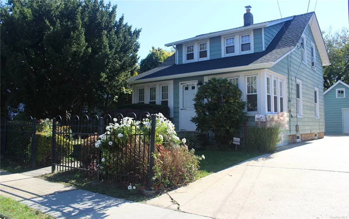 Beautiful Expanded Cape in Merrick School District set on 50x145 Private Property. Features Enclosed Heated Porch, LR/DR,  Bright Updated Kitchen, 3 Bedrooms (including 1st Flr Master), 1 1/2 baths, HW Flrs, Beautiful Wood Doors, Moldings, and Built-ins, 2021 Roof, Unfinished Bsmt w/OSE, Gas Heating System, Detached 2 Car Garage with Loft for Storage and Gardening Shed in Back, Large, Private Yard. Walk to LIRR and Shopping. Wonderful Community. Make this Beautiful Home Yours!