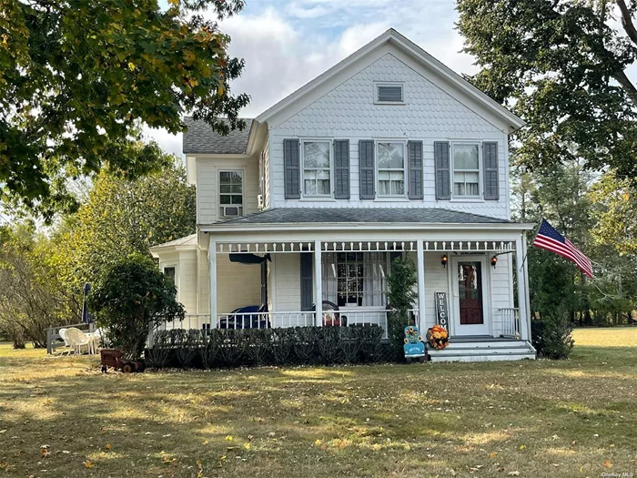 Southold, North Fork: The historic Boisseau farmhouse, built around 1890, is situated on 1.75 acres (76, 230 square feet) with R40 residential zoning, in a picturesque setting featuring mature trees and a sprawling lawn. The property is adjacent to fallow, and partially wooded acreage owned by the Town of Southold. The traditional home boasts a charming covered front porch, an entry foyer, and a spacious living room with a fireplace. The dining room can function as a den and includes pocket doors. The primary floor also offers an eat-in kitchen, a laundry room/pantry, a 3-season room, a full bath, and a back staircase. Upstairs, you will find three large bedrooms and another full bath. The farmhouse retains historic character and details, including original wainscoting, paneled doors, windows, and hardwood floors. Various unique features from a bygone era include a laundry chute, a built-in medicine cabinet, bench seats and cabinets, and a sewing room or nursery that could also serve as a walk-in closet. Additionally, the property includes a two-car garage, a post-and-beam barn (which previously hosted generations of local school dances), a large two-story workshop, and a tool shed, along with the &rsquo;tower&rsquo; of the windmill that once pumped water for the farm. With approximately 200 linear feet of road frontage, this home offers substantial privacy and is ideal for those seeking a true North Fork residence within a village setting with access to Southold Park District amenities including use of the Wharf House. You can have it all at 2055 Boisseau Avenue, with room for a pool or tennis court, horses, or small-scale farming. The barn can accommodate multiple boats or cars. Follow your dreams and explore this incredible opportunity!