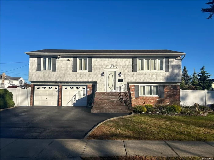 Spacious Wideline Hi Ranch Located in Massapequa School District. Great Location; Close to LIRR, Massapequa Lake, Shops & Restaurants. Oversized Property Fenced in PVC w/, 2 Side Yards & Rear Patio. Oak Floors Throughout Top Floor Under Carpets. Deep 2 Car Garage & Wide Blacktop Driveway. Inground Sprinklers & 200 Amp Electrical Panel. Top Floor Has 3 Bedrooms 1 Bath, Large Eat in Kitchen, Formal Dining Room & Living Room. Lower Level Has a Large Bedroom, Full Bath, Den/Living Room w/ Sliders to Rear Patio & Access to Garage. Pull Down Attic & Shed For Additional Storage. PROFESSIONAL PHOTOS BY THE END OF THE WEEK!