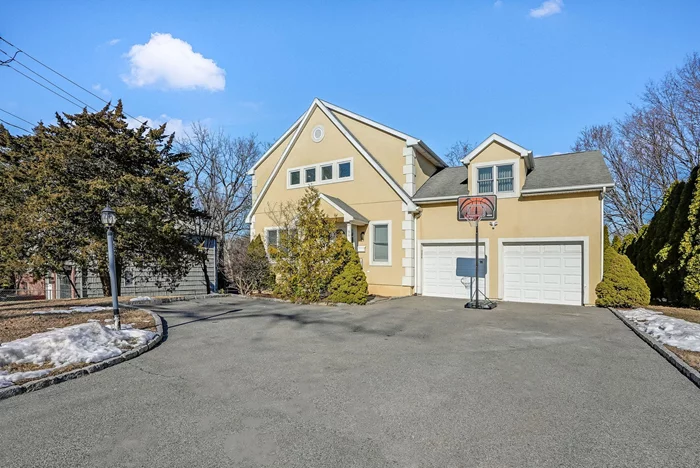 This Colonial sits on a level property with a garage and lots of driveway parking! The entrance hall leads to the formal living room, dining room, a kitchen with island seating and a full pantry closet, an additional dining area, and sliding glass doors to the deck, an adjacent family room with a woodburning fireplace and a powder room. Access to the two car garage through the kitchen. Upstairs is the primary bedroom with a walk-in closet and en suite bath with dual sinks, tub and separate shower. There are three additional bedrooms and a hall bath. The lower level has a rec room, fifth bedroom/home office and a laundry room. Plenty of yard space for play and entertaining. Close to Central School, Hommocks and shopping. Fantastic rental ready now for you to move right in.