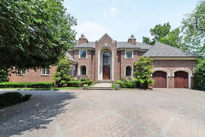 Located in Woodsburgh, Long Island, this stunning brick colonial home, built in 2001 on 1.09 acres, offers luxury living in the 5 Towns. Featuring 8 bedrooms, 9 full and 3 half baths, a private guest entrance, and two laundry rooms, the home is designed for elegance and convenience. An elevator connects all four floors, including a finished basement with an 8â€™ ceiling, party room, catering kitchen, theater, playroom, fitness room, sauna, steam room, and indoor endless pool. Vaulted ceilings, custom lighting, marble radiant heated floors, and exquisite millwork enhance the sophisticated ambiance. The chef&rsquo;s kitchen boasts double major appliances, while patios off the living room, family room, kitchen, and master suite extend the entertaining space. Outdoors, enjoy an in-ground heated pool, hot tub, water slide, diving board, built-in barbecue, lounging areas, and a sports court. Two attached 2-car garages complete this exceptional home, ideal for entertaining and luxury living.