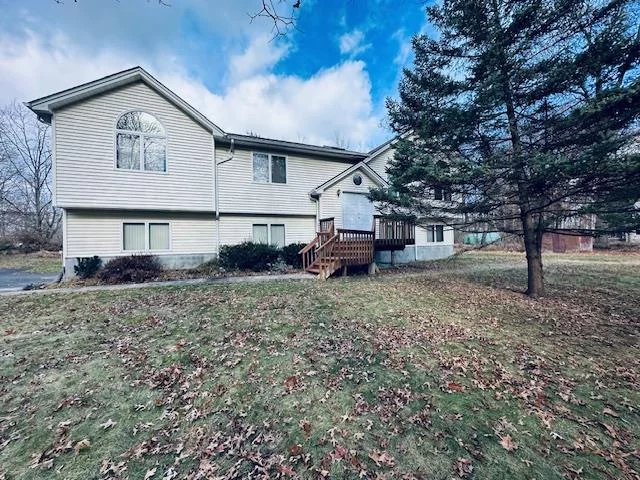 Bardonia, NY 10954. Step into this bright and spacious contemporary home, set on over half an acre of level property, and experience modern living at its finest. Boasting 4 bedrooms and 3 full baths, this home features an open floor plan with cathedral ceilings that create an airy and inviting atmosphere. Enjoy the updated kitchen with granite countertops and backsplash including a functional island, perfect for entertaining and everyday living. The large primary-bedroom suite offers a walk-in closet and a private bathroom with a double sink vanity, a separate shower, and a relaxing jacuzzi tub. Two additional bedrooms (one currently used as an office) and another full hallway bath complete the upper level. The walkout lower level includes a spacious family room with a wood stove, a nicely sized bedroom with a large closet providing ample space for guests or family, a full bath, and a laundry room. wood floors in kitchen and dining area refinished Hardwood floors throughout the home add elegance and easy maintenance. Central air and hot water baseboard heat ensure comfort year-round. An 8kW Generac automatic home standby generator provides peace of mind. Oversized 2-car garage with ample storage space. The property&rsquo;s layout also makes Located within the top-ranked Clarkstown Central school district. This home offers a private community setting perfect for family living.