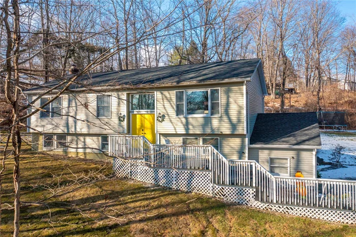 This charming, tucked-away Raised Ranch offers 3 bedrooms and 2 bathrooms, providing a cozy and modern living space. As you step through the front door and ascend the stairs, you&rsquo;re greeted by a bright and airy living room featuring a bay window and hardwood floors, which seamlessly flow into the dining area and open kitchen. The updated kitchen is equipped with stainless steel appliances, granite countertops, and a breakfast bar, with a door leading out to the back deck â€” perfect for entertaining or relaxing. Down the hallway, you&rsquo;ll find two generously sized bedrooms, both with hardwood floors, and an updated hall bathroom. The primary suite also features hardwood floors and an updated en-suite bathroom, complete with a luxurious tiled walk-in shower. The lower level provides even more space for living or entertaining, with a large laundry and mechanical room, a convenient half bath, and a spacious tiled living area with a cozy wood-burning stove. Additionally, there is a two-car garage, offering plenty of storage and parking space.