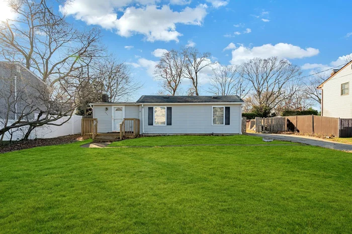 Charming 2-bedroom, 1-bathroom bungalow located in Lindenhurst on a spacious 0.251-acre lot. This home features vinyl siding and a welcoming wood porch. The flat front and back yards provide plenty of outdoor space, with an additional lot behind the property included in the purchase.Step into the cozy den with a wood-burning fireplace, leading to a living room just a step up. The two front-facing bedrooms offer ample closet space. The kitchen is tiled and bright, with wrap-around cabinetry, large windows for natural light, and an eat-in area. A rear door leads to the expansive backyard.The basement provides storage and houses the laundry, utilities, and an oil tank. Updates include a modern boiler and a 200-amp electric panel. Conveniently located near Sunrise Highway and shopping, this home combines charm and accessibility. With village taxes of $701, which include the extra lot, this property offers great value.Donâ€™t miss out on this opportunityâ€”schedule your showing today!