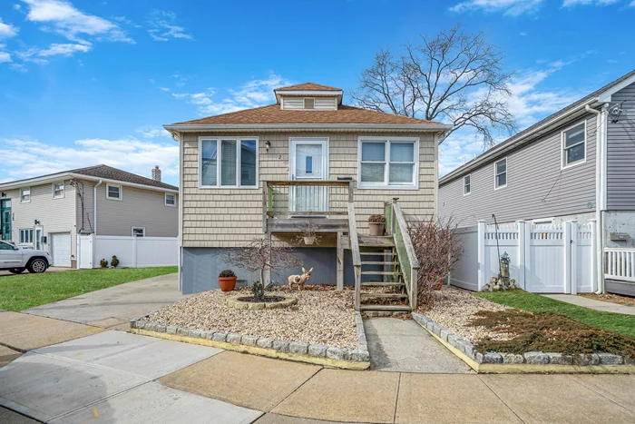 Beautifully maintained and fully FEMA compliant, this home is ready for you to move right in. Step into the spacious living room featuring two skylights and a grand 15-foot vaulted ceiling, lending an airy and open feel. The house is equipped with high-end central air conditioning, custom bathroom and kitchen cabinets, stainless steel appliances, and granite countertops. Outside, the property is adorned with a beautifully landscaped yard with a PVC fence and a 1.5-car detached garage.Ideally situated within walking distance to the LIRR, nice restaurants, and the beach, this home offers a fantastic opportunity. The seller has received an exceptional job offer way out the East of Long Island and has priced the property competitively for a quick sale. Call NOW to make this exceptional home YOURS before anyone else takes it!