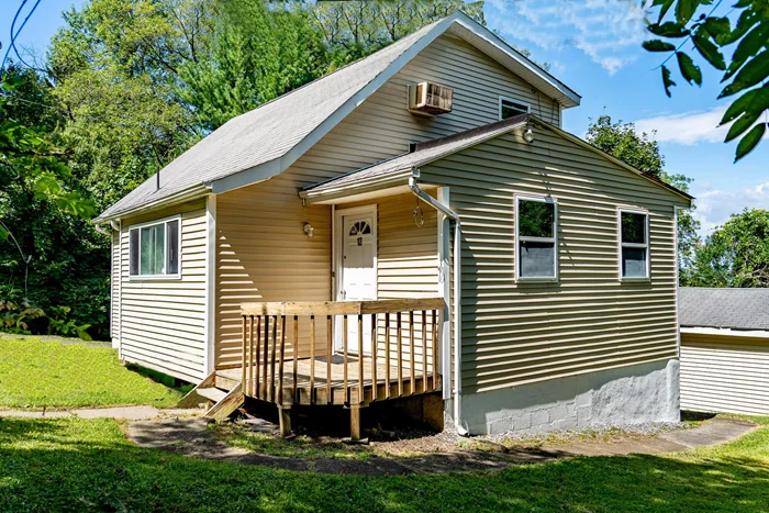 Welcome to this charming 3-bedroom, 1-bath home built in 1955 is nicely nestled on the shoulder of Schunnermunk Mountain in Monroe, NY. This property is situated on a large 6, 499 sq ft lot, offering privacy and a strong connection to nature. As you step inside, you will be greeted by a cozy foyer and a bonus room. The spacious living room seamlessly flows into an oversized kitchen, perfect for entertaining guests or simply unwinding at the end of the day. The dormered oversized upstairs room serves as a wonderful master suite, complete with its own heating zone and ample storage/closet space. There is ample parking with a double carport in front of the home, and a private driveway leading to a private garage. The property also boasts its own well for year-round water supply. Community amenities, such as a playground and basketball courts that are located just down the road.