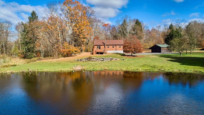 Privacy and a cozy home await you in the hills of Callicoon! Charming log cabin with front porch and deck overlooking a beautiful pond, with frontage on an even larger pond where you might train for the next Delaware River regatta! And not to forget the 26 acres of property for hiking and enjoying, a detached 2 car garage with car port in the rear, and a large barn/studio for all your creative endeavors. The lower level of the home is finished and has a full bath. There is room for the young crowd to play ping pong or watch their favorite movies. The main level offers a living/dining/kitchen with a wood burning fireplace, 2 bedrooms and a full bath. Use the loft bunk room as your private retreat, or again for the young crowd. This is a property where sellers and their family made unforgettable memories over the years of their ownership, be it in winter, spring, summer, or fall. Don&rsquo;t delay. You just found your family&rsquo;s happy place!