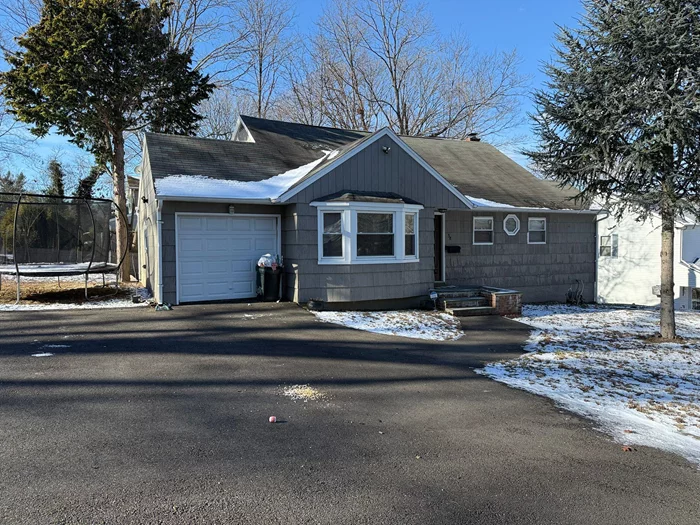 Welcome to 38 Gatelot Avenue in Ronkonkoma. This 4 bedroom 2 Bathroom split level home is completely updated with modern finishes. This property is situated on a corner lot and has large driveway. Hardwood floors throughout the home. On the top level there are 3 nice sized bedrooms with full bathroom. The middle level features a large living room with access to the garage and a modern kitchen that is open and has stainless steel appliances and quartz countertops. The bottom level has a full bedroom, a bathroom, the utility room, a closet with a washer dryer hook up, and has access to the backyard. Prime location, near shopping centers, barbershops, access to the 495, and restaurants, and much more!!