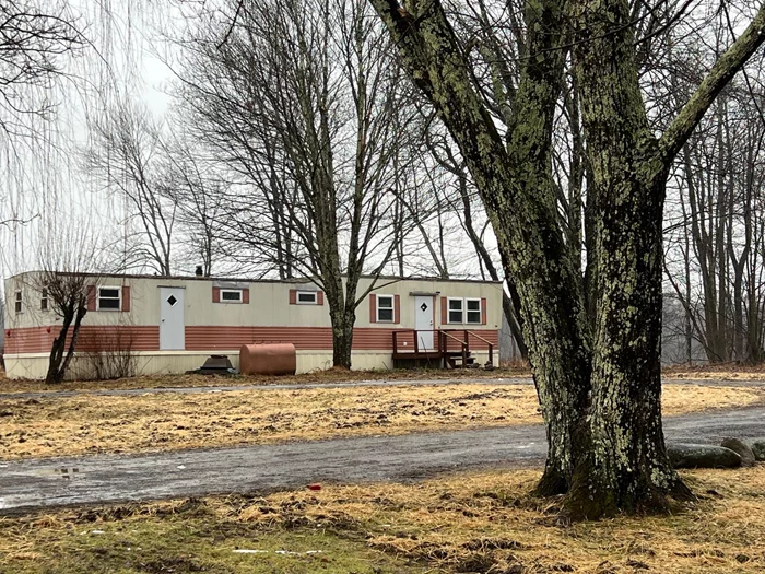 This charming two-story cottage, set on1/5 serene acres along a country road in the heart of the quaint hamlet of Accord is the perfect base camp for all your Hudson Valley adventures. The property features a detached 20x24 garage with an overhead door and a vintage mobile home with its own separate driveway â€“ offering great potential for additional uses.The cottage is move-in ready with a full bathroom, bedroom, cozy living room, laundry area, large eat-in kitchen and a den.Whether you use the existing floor plan or reimagine the space to suit your needs, this home offers plenty of possibilities.Upstairs there is an additional bedroom and a sitting area that could be converted into a third bedroom. The layout provides flexibility for creating extra sleeping space, a home office, or a cozy retreat.Outside, the large, level side and rear yard offer stunning mountain views and ample space for stargazing around the fire pit or cultivating a garden.The property has one well and two septic systems, one for each dwelling. The seller makes no representations regarding the mobile home on the property. The home also features a newer goiler for reliable heating.Whether youâ€™re seeking a full-time residence, a weekend getaway or something in between, this property offers the perfect opportunity to enjoy all that the magnificent Hudson Valley has to offer.