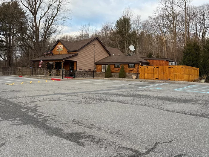 Located in Orange County, NY, in the Town of Wallkill, the Horse and Sulky Tavern (Real Estate Only for Sale) is a prime investment opportunity. The current occupant will lease back with terms to be agreed upon. This tavern boasts an established business featuring state-of-the-art refrigeration and ice machines, a walk-in keg room & cooler, and a wrap-around bar that seats over 30 guests. The professional bar setup includes cold beer taps, a soda machine dispenser, four stainless steel sinks, newer roll-top coolers, prep stations, a center island for the register, and ample cabinets and shelving,  dining room offers additional seating with tables and booths, complemented by vaulted ceilings, ambiance, and recessed lighting throughout. updated floors, along with wood barrel accents on the ceilings, add to the charm. The commercial kitchen is equipped with two ovens, fryers, a pizza oven, four stainless steel sinks, prep stations, and racks, all supported by a state-of-the-art venting system. Outside, there&rsquo;s a patio with a wrap-around cement front porch and stone columns, plus three restrooms. Ample paved parking provides visibility and easy ingress and egress. Situated in the Light Enterprise District in the Town of Wallkill, this property offers numerous permitted uses.