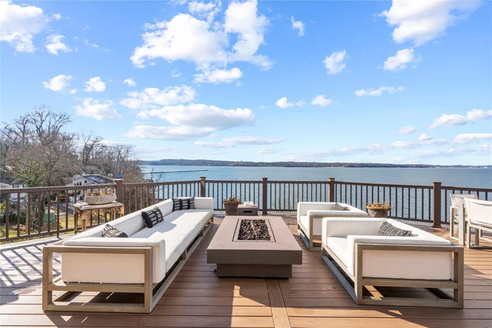 Luxury Beachfront Retreat - what a way to live! You will feel like you are on vacation at this completely renovated gorgeous waterfront condo designed for entertaining in the heart of the Glen Cove/Locust Valley area better known as â€œThe new Hamptonsâ€ complete with elevator. About an hour commute from Manhattan, this exciting eight-bedroom, seven-and-a-half-bath contemporary provides ample room, in pristine condition, for you to enjoy its three levels of luxury living space. Breathtaking vistas of Hempstead Harbor and Long Island Sound can be viewed through seemingly endless walls of glass, expansive decks, and private bedroom balconies. Its open floor plan, including glass balustrades on staircases and lofts, fills the home with water vistas. Located off a cul-de-sac, your future home offers ample parking for guests and a two-car garage for yourself. In the scenic and peaceful community of Waterâ€™s Edge, where small clusters of condos are woven in amongst lovely sprawling lawns dotted by mature trees, the home is just steps down to the waterfront, beach, and clubhouse. In another area of the complex, a pool, tennis court, and pickleball court are ready for your enjoyment. Double doors welcome your guests into a bright and inviting main level that boasts a fabulous eat-in cookâ€™s kitchen with huge center island, high-end appliances, and a serving bar equipped to serve any beverage from cocktails to coffee. Windows overlooking the water extend the length of the space, through the spacious dining area, and into the sunny and welcoming living room with sliders to a huge sunny deck overlooking the water, Sands Point, a distant lighthouse, and the twinkling lights of New Rochelle. In the summer, you can watch yacht club regattas and in winter, enjoy the homeâ€™s two cozy gas fireplaces. Any season, you will be enthralled by gorgeous sunsets across the water. A hallway, running from the foyerâ€™s powder room and mud/laundry room to the living room, leads to staircases and an elevator accessing upper and lower floors, and to the palatial primary suite offering privacy and serenity in its lavish bedroom with doors to the huge rear deck, built-in cabinetry and entertainment center, and a luxurious marble three-room primary bath boasting a large twin vanity, Roman tub, separate shower, and water closet with commode and bidet. A staircase ascending to the upper level features a clear-glass balustrade that continues across a spacious loft that provides incredible views of water, sky, and living room. This cozy seating area flows into a sun-drenched state-of-the-art gym with a large closet and full bath with shower. Across the landing, with glass balustrades overlooking the main level, are two spacious bedrooms, each with its own bath, closet, and balcony. For convenience, you can take the elevator or the stairs to the lower level. With its own second kitchen, and two entrances to the wraparound lower deck, it could serve as a delightful guest suite with three bedrooms with baths ensuite. Also on this level are a large utility room and a brick-and-glass-lined wine cellar that could also serve as an indoor garden. A few steps down from the hall, a fun recreation room will provide hours of entertainment with a pool table, fireplace, wet-bar, and glass doors opening to an immense covered deck overlooking the water. The comfort and amenities of this like-new home are augmented by its ideal location surrounded by so many historical and nature sites to see plus parks, beaches, boating, golf, mansion museums to explore, quaint village shops and restaurants, and an active nightlife. And donâ€™t forget all the wonders and pleasures of nearby New York City. View 3D tour and floor plan.