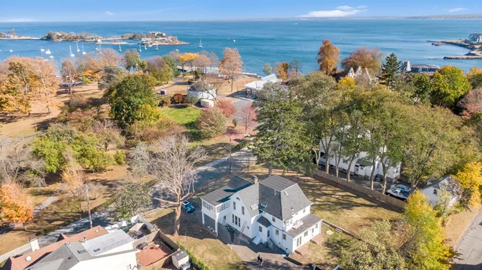 Welcome to your very own tranquil oasis with period details, an abundance of character and peaceful views on all floors. Sun-bathed Vintage Victorian with Porte cochere is perfectly oriented with high ceilings and huge expanses of glass to take in beautiful sunrises. Only 7 homes make up this Special Enclave with a sandy 300-ft private beach on Long Island Sound. Imagine kayaking, paddle boarding and swimming from the water&rsquo;s edge. Step inside to this amazing 3, 547 -sf interior uniquely designed for grand entertainment. First level entry foyer has a brick fireplace, an expansive living room, grand fireplace and French Doors leading to the formal elegant Dining Room with floor to ceiling windows, modern dine-in kitchen, adjacent family room, full bath. Plus a peaceful sun room overlooking the marina and park. A wonderful designed first floor facilitates a smooth transition between indoor and outdoor areas. Upstairs, primary bedroom, skylight, walk-in closet & primary bath. Delightful Guest Bedroom offers nature & water views plus a separate space to read, paint and relax. Watch the boats enter the marina from the second floor enclosed porch. Three additional bedrooms & a hall bath complete the second floor. All rooms feature handsome hardwood floors. A half acre setting with sweeping lawn has room for an in-ground pool (135 x 149 ). 4 car Barn/Carriage House with second floor originally had a bath/shower.