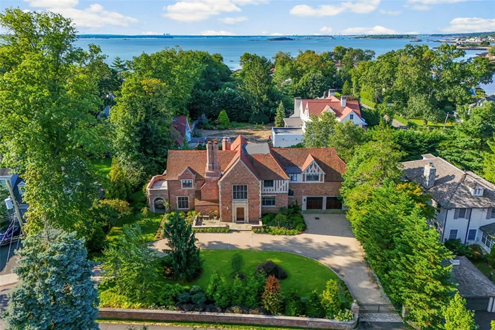 This magnificent and elegant Larchmont Manor home showcases stunning finishes, exceptional craftsmanship, and a grand, gracious layout that is perfect for both family living and entertaining. A dramatic entry hallway leads to a light-filled sunken living room with a beautiful wood-burning fireplace and sliding doors that open to a private patio. The elegant dining room, renovated powder room, and cozy library with fireplace provide versatile spaces for relaxation and formal gatherings. The fully renovated eat-in kitchen is a chefâ€™s dream, featuring high-end appliances, custom cabinetry, and beautiful marble countertops, with French doors leading to a spacious wooden deck with two umbrellas, ideal for outdoor entertaining. An oversized mudroom with plenty of storage provides convenient access to the garage. Upstairs, a grand staircase leads to the primary suite, which includes two walk-in closets and an elegant en-suite bathroom and door to a private balcony, there are four additional bedrooms that share two Jack-and-Jill bathrooms, and two hall bedrooms that share a hall bath. The lower level offers a large recreation room with an original built-in bar and stone fireplace, plus a stunning home gym. With its exceptional design, generous living spaces, and luxurious finishes, this home offers the perfect blend of elegance and modern comfort in Larchmont Manor, located only steps from the Long Island sound, manor beach and park.