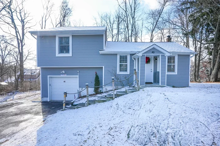 Welcome to 45 Livingston Road in Lake Carmel!!! This beautifully remodeled home features a cozy open living space with recessed lighting throughout. Large flat corner lot with parking for 5+ and a heated garage. Full bathrooms on each floor with modern tile and new fixtures. Conveniently located - 2 miles to I84 - 20 mins to Danbury and Wappingers - WORRY FREE - MOVE IN READY - New features include: roof, siding, plumbing, electric, windows, appliances, cabinets, flooring, bathtubs, vanities and more!! Each bedroom has its own heating zone.  New water heater, new water well tank, septic tank has recently been pumped and checked and given a clean bill of health. Lake rights for swimming in the summer days.