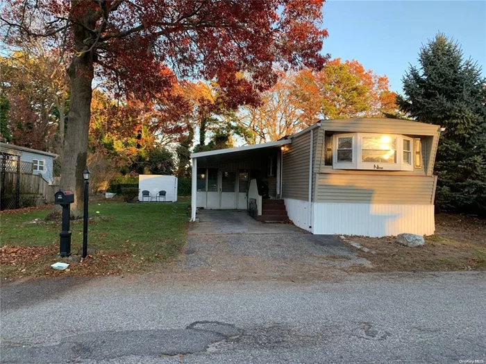 Move right in to this beautifully renovated 2-bedroom, 1 bath home located in the quiet Bunker Valley Community. This open concept home features a new Eat-in-Kitchen stainless steel appliances, which include a new dishwasher, microwave, gas stove and refrigerator. This home has newly installed flooring throughout. Upgrades also include many new energy efficient windows, upgraded insulation and an updated bathroom with tub. The roof was replaced in 2022 and there is a newly installed hot water heater. There is a three seasons room for entertaining, an outside shed for storage, and a covered carport.  Washer and dryer are also included in the home. The monthly park fee of 1257 includes property taxes, land rent, water, sewer, garbage and snow removal. This home is NYS STAR discount eligible which is not reflected above. The community has no age restriction and allows pets. Financing available!