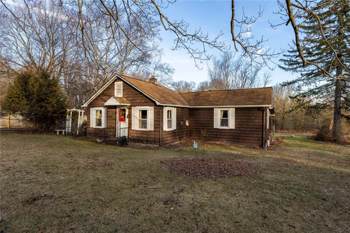 Experience the charm of this 3-bedroom, 1-bath ranch style cottage nestled on a tranquil property in the heart of New Paltz. Located within minutes to SUNY New Paltz, Main St, and New Paltz Senior High School while surrounded by nature, this home blends cozy interiors with stunning outdoor views. Inside, enjoy a warm, sunlit living area, an inviting sunroom, and a seamless flow between the kitchen, dining, and living spaces. The primary bedroom offers privacy, while the other two bedrooms, one a pass-through, add flexibility. Outside, the manicured yard and mature trees create a peaceful retreat, perfect for relaxing or exploring. Conveniently located near hiking trails and state parks, this home combines comfort and natural beauty.