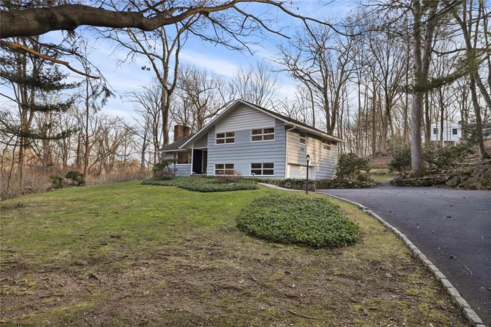 Fresh and inviting split-level home conveniently located close to town. This light-filled residence features beautifully refinished wood floors, a soothing paint palette, and a cozy atmosphere throughout. The living room with attractive brick fireplace opens into the dining area and bright kitchen with white cabinetry and stainless appliances. Steps down from the kitchen is a recreation room with door to patio, and garage access. Another short flight of stairs leads to the unfinished basement with lots of storage and laundry area. The upper level includes the primary suite with updated bath and two additional bedrooms with a hall bath. Beautiful, private setting with patio for entertaining and a spacious rear yard. Minutes to town shops, restaurants, parks & groceries. Lawn maintenance included.