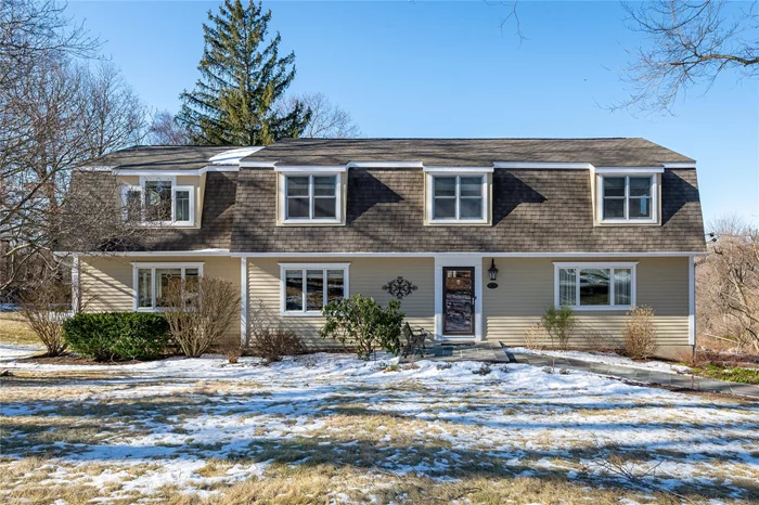 Elegant and spacious, this 4-bedroom, 2 full/2 half bath Colonial is nestled on a private 1-acre lot, offering breathtaking views from its mahogany deck. The inviting layout begins with a tiled foyer leading to an eat-in kitchen with granite countertops and a sunlit breakfast area. A formal dining room flows into a cozy sitting area with a wood-burning fireplace, adding warmth and charm. The bright living room offers a perfect place to unwind, while the family room, with French doors leading to the deck, provides an additional space for relaxation. Upstairs, a private sitting room leads to the elegant primary suite, featuring French doors to a private balcony, a walk-in closet, and boasts a luxurious full bath with a steam shower. Three additional bedrooms, a full hall bath, and a half bath complete the second level. The finished basement offers a home office, a dedicated laundry area, and abundant storage. The home is hardwired for both smoke and carbon monoxide detection, offering enhanced safety and peace of mind.  Ideally situated near Metro-North, schools, and shopping and just a short walk to Joe Bohrdrum Park. A fantastic location with everything you need nearby!