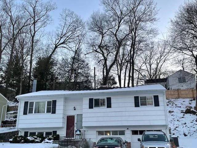 This charming raised ranch in Sloatsburg, NY, features four spacious bedrooms and two full bathrooms, making it an ideal place to call home. The interior boasts beautiful hardwood floors and is flooded with natural light from skylights throughout, creating a warm and inviting atmosphere. The finished basement includes an additional bedroom and a cozy fireplace, perfect for relaxation or entertaining. The property offers a driveway that accommodates up to four cars, ensuring ample parking for family and guests. Residents can enjoy access to two private lakes for swimming (lifeguard on duty), kayaking, and fishing, along with a full basketball court, playground, and BBQ grills, making it perfect for entertaining. Being sold strictly AS IS.