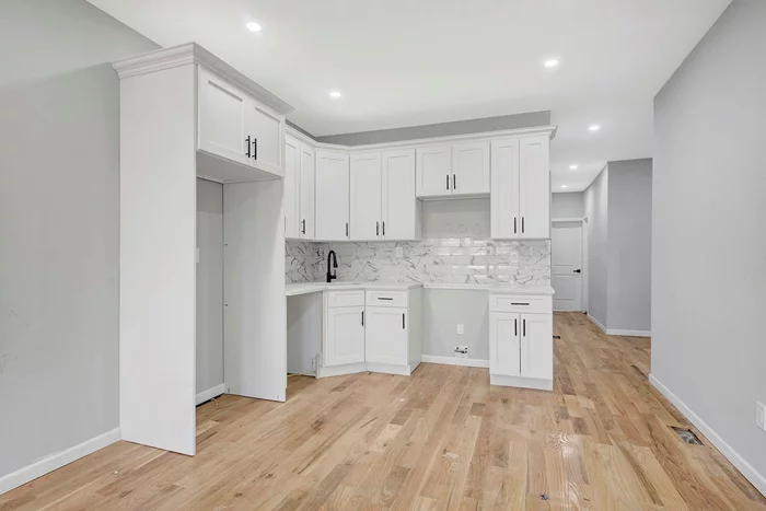 Situated on a beautiful tree lined street of Richmond Hill, 126-08 95th Avenue is a newly renovated, turn key move in ready two family which provides the perfect opportunity for buyers looking for space, plus income generating rental property to assist with mortgage payments. This 20x55 townhouse spans over 3, 300 sq/ft of living space!Configured as 3 bedroom 2 bath rental unit which has the ability to generate $3, 600/month to assist with mortgage payments. The Garden unit consist of 3 bedrooms and has access to the rear yard. The basement has separate entrance and has 2 additional bedrooms, a full bath and a summer kitchen. Both units enjoy expansive sun drenched living/dining areas which provide great space for entertaining. Beautiful chefs granite kitchens equipped with floor to ceiling custom cabinetry and adorned with a full fleet of stainless steel appliances. Spacious bedrooms equipped with ample closet space. Fully tiled bathrooms adorned with state of the art wall & floor tiles. Renovations include brand new hardwood flooring, recessed lighting, updated electrical, heating and plumbing systems throughout. 126-08-95th Avenue is conveniently located with close proximity to major transportation which makes commuting a breeze. Just off Atlantic Avenue, Van Wyck Expressway, 101 Avenue and Liberty Avenue. Short blocks to LIRR Jamaica Station, E & F Subway lines.