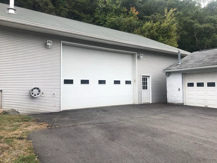 Spacious heated garage at 249 Route 210, Stony Point, NY with a ceiling height of 13â€™ 9â€. Features an 18â€™ wide by 12â€™ high garage door and a large mezzanine for additional storage (not included in square footage). Ideal for contractors, storage, or a versatile workspace. Donâ€™t miss this functional and well-equipped space!