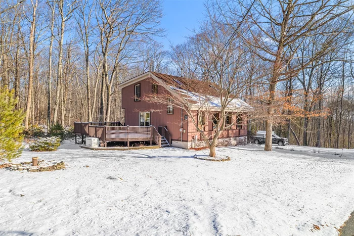 Nestled in the serene countryside of Wurtsboro, NY, this one-of-a-kind home offers an exceptional blend of rustic charm and modern amenities. This home features an open concept living area with abundant natural light, creating an inviting and airy atmosphere. Upon entering, you are greeted with soaring vaulted wood beamed ceilings with a fantastic stone, two-story woodburning fireplace. The eat-in kitchen offers granite countertops, stainless steel appliances and access to the two-tiered deck which is ideal for entertaining. Spacious formal dining room and a full bathroom complete the main level. The wide wooden staircase leads to the second story loft overlooking the living area and leads to two bedrooms and a jack-and-jill bathroom. The exposed beams, custom woodwork, and large windows frame the picturesque views allowing you to experience the surrounding nature from indoors. Just a short drive to the historic Village of Wurtsboro with local shops, restaurants, outdoor activities, and the famous Canal Towne Emporium country store. There is something for everyone to do...hikers, bikers, nature lovers, and art enthusiasts. Located in the Mountain Lake Camps community, you can have access to the pool, clubhouse, and tennis courts for a yearly fee. Only about 1 hour and 20 minutes into NYC. Close to Resorts World Catskill and Kartrite Resort & Indoor Waterpark, Bashakill Winery, and Holiday Mountain for winter sports. Updates to include an automatic whole house generator, central air, newer boiler, well pump, and hot water heater. Fenced in backyard for added convenience. With its distinctive design and scenic surroundings, this property is perfect for those seeking a peaceful retreat or full-time residence.