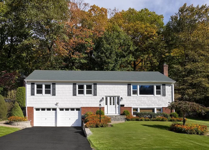 This versatile and pristinely-maintained 2325 SF 4 bedroom home will dazzle you with its sense of expanse, both indoors and out. Placed on a level, double-wide .23 acre property, just one block away from the cherished Juhring Estate in Dobbs Ferry, 82 Briary offers spaciousness along with many options for flexible living. A large open-concept living/dining area overlooks the double-height entry, luring you up into its grand entertaining space with burnished oak floors and tons of light. The view over the front yard, through a new picture windows, showcases a vast western sky, while the view from the dining table looks out to the evergreen edge of the rear yard and wooded hillside beyond. Flooded in eastern light, an modern eat-in kitchen features stainless appliances, corner sink, granite counters and floor. A glass door leads directly onto a generous deck for outdoor enjoyment. Each bedroom on this level includes oak floors, double-wide closets, and sunny exposures, while the primary includes an ensuite tiled bath with a lovely view of its own. An adaptable layout on the level below presents useful possibilities. Discover an extremely spacious family room/bedroom with its own ensuite bath. Through a pair of French doors, it has direct access to a private, covered bluestone patio with stone knee walls â€“ making this area perfect for home office, guest suite, or potentially converting to an accessory dwelling unit. Completing this level is an imagination-inspiring finished storage room with new picture window and an amply-outfitted laundry room that leads to a huge 2-car garage affording tons of storage space. Opportunities abound outdoors as well. In the backyard, three distinct areas present alternatives for family and guests to mingle. A stone retaining wall - running the width of the rear property line - creates a raised cypress privacy partition, while allowing for some inspired gardening, as well, while a grassy side yard is ideal for lawn games. Just up the street, the 76 acres of the Juhring Nature Preserve awaits, while Gould Park/Pool, award-winning public schools, and a vibrant village downtown are close-by. If you are seeking a home that can provide you with opportunities to accommodate your specific lifestyle, this house should be tops on your list.