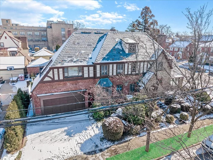 Stunning, Enchanting, English Tudor. This beautiful homes features 2600 square feet of living space across 1st, 2nd, and 3rd floors. Featuring 5 Bedrooms, 2.5 Baths. This beautiful home has it all. The 1st floor consists of a large separate eat-in-kitchen, formal dining room, large living room with a wood burning fire place, a sunroom (den or office use), and enclosed outdoor covered room. The second floor consists of a large primary suite with its own ensuite bathroom, 3 generous sized bedrooms, and a full renovated hallway bathroom.  The third floor walk up has another sleeping quarters and a large unfinised space. There is a full finished basement showcasing 2 muilti-purpose living areas with a wood burning fire place that make it a great room for entertaining and gathering.  Many Tudor characteristics and Tudor charm throughout. The beautiful exterior of this home includes steep gables, decorative timbering, and a slate roof which makes it a timeless piece of architectural elegance. The corner property is situated on 4900 (49 x100) square foot lot with beautiful landscaping, and lush green lawns. Near All, major highways, walk to Long Island Railroad, MTA Buses, shopping, dining, and schools (school district #25).