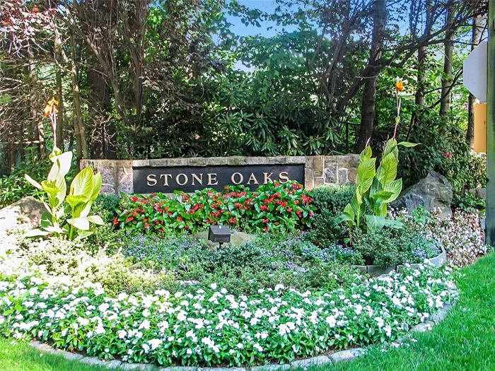 Discover carefree living in this three level, end unit townhome on a private cul-de-sac in coveted Stone Oaks 24-hour gated community. Known for its beautifully manicured gardens and private wooded setting and resort-like amenities including pool, tennis, fitness center and clubhouse. The sunlit first level boasts open concept living and dining room with hardwood floors and glass doors to the large deck. The sizable kitchen has an eat-in breakfast area with a wall of floor to ceiling windows overlooking the private courtyard. A den/office and powder room complete this level. On the second level is an expansive primary suite includes two exposures, four closets (three walk-in) and bright en-suite bath. A second bedroom, hall bath and convenient laundry room are also on this level. The oversized finished lower level family room with sliders to the patio and back yard offers versatile space for gym, office or guest room. A 2-car attached garage, ample driveway space and plentiful outdoor areas to relax and enjoy. HOA includes exterior maintenance, common area maintenance, landscaping, trash, snow removal. Convenient to shops, farmers markets and restaurants as well as Hartsdale Metro North train and Sprain Brook Parkway for a 30 minute ride to NYC. Don&rsquo;t miss this opportunity!