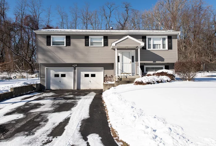 Pristine Spackenkill home impeccably maintained by the original owners. The immediate appeal of this home begins with the exterior, highlighted by a newer roof, driveway and siding all perfectly punctuated by a lovely portico which shields you and your guests from the elements. As you ascend the interior stairs you are treated to new carpeting. If you prefer hardwood floors, not to worry, as there are hardwood floors under the carpeting which have always been covered and protected. The living room is spacious, flooded with natural light and flows effortlessly into the dining room. The kitchen offers sleek cabinetry, plenty of storage, a dine-in area and access to an expansive 3 season room which includes an entire wall of windows from which you can take in nature and bring in the outdoors. In the warmer weather, head out to the Trex deck for some sun and fresh air. You will love the level, fenced back yard. If it gets too hot, head back inside and cool off with central air. A generous primary bedroom, two additional bedrooms and an updated full bath complete the main level. There is also a fully finished lower level; a perfect place to entertain or simply retreat, relax and watch some TV after a long day. The half bath is an added bonus. This is truly a move-in condition home. All of the big ticket, costly items have been done. Simply unpack your bags and make it your own. Located in the Spackenkill school district, conveniently located close to shopping, schools, medical facilities, restaurants, public transportation, the Poughkeepsie train station and all that the fantastic Hudson Valley has to offer.