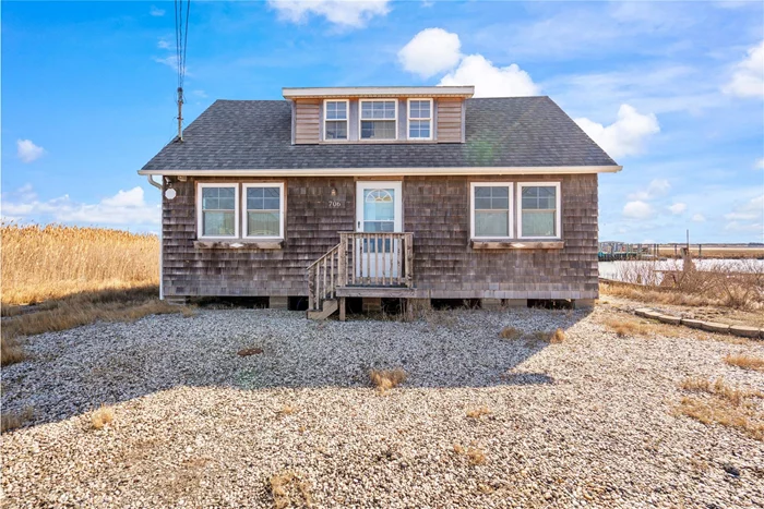 Incredible waterfront opportunity. Adorable cape with panoramic views both east and west, overlooking Narrow Bay with bulkhead and boat ramp. Just a mile from Brookhaven Town&rsquo;s planned and approved downtown revitalization project, set to break ground soon. Ask me about the Army Corps of Engineers program that will raise this home at ZERO cost to you! A listing like this at a price like this is extremely rare. Roof is young and in great condition, original wood floors in great condition as well. The interior is charming and stylish, with a kitchen island and a custom built-in breakfast nook with marble table. Features a guest room on the lower level with built-in closet/storage, and upper level features 2 small bedrooms, an office area with wide-plank wood flooring and a large window overlooking the bay (upper level was originally setup as one large bedroom). Deck with pergola and outdoor shower completes what is the ultimate beach town retreat. Hot water heater installed for running water, but currently no heating system in place. Installation of a split unit for heat and AC would be an easy and efficient fix. Very low taxes.